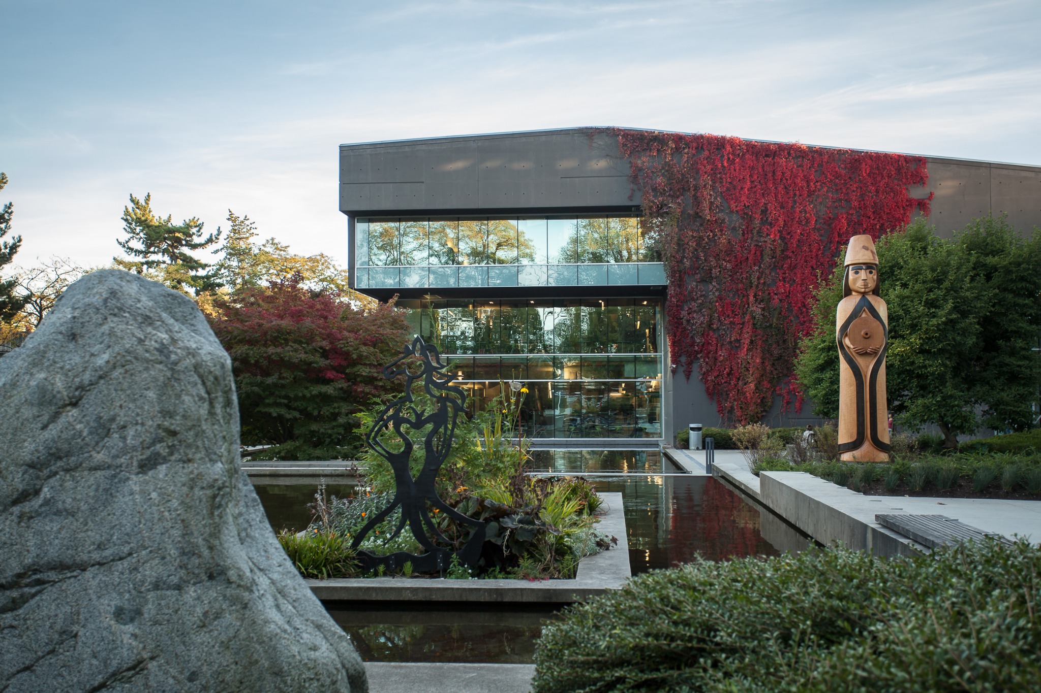 The Langara library, Musqueam house post, and rock.